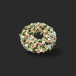 couronne de deuil Genève : roses pastel, marguerites et chrysanthèmes pour un hommage élégant